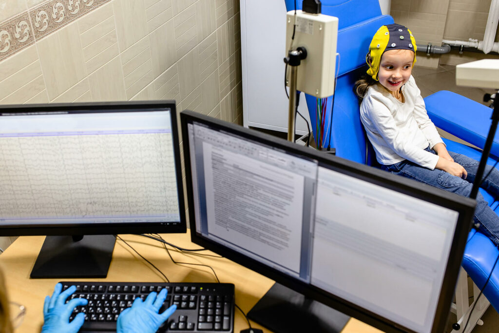 Child with a QEEG cap on while participating in Neurofeedback Training in DC to treat ADHD or other mental health issues.