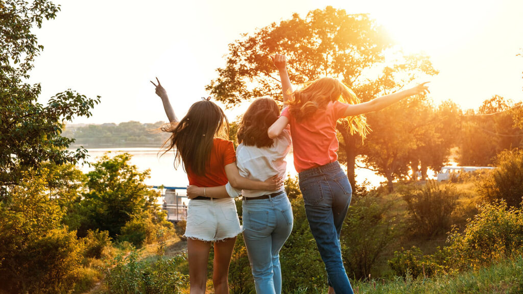 Group of young women walking happily with their arms around each other representing women who have overcome depression with the help of Therapy for Depression in Washington, DC.