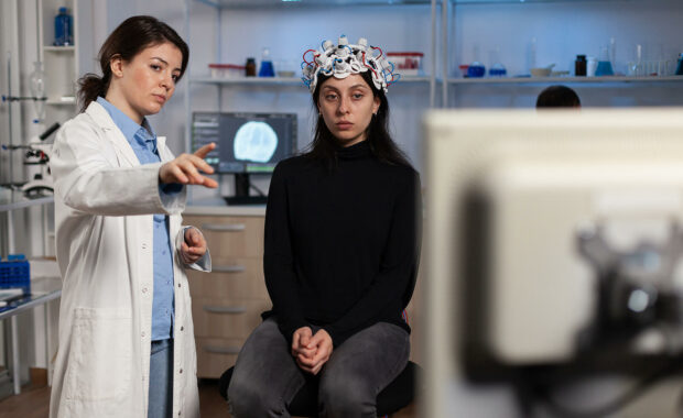 Woman in an EEG cap working with a clinician representing the process of brain mapping as part of Neurofeedback for Depression in Washington, DC.