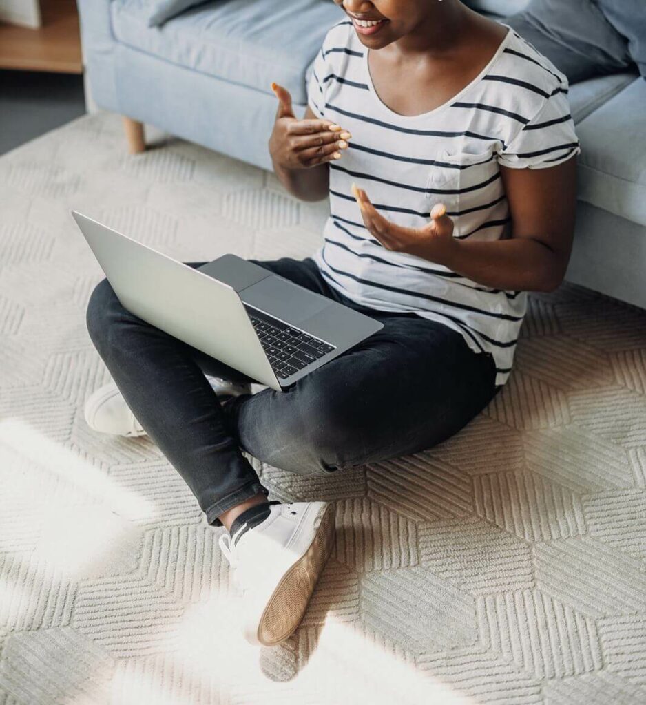 An individual participates in CBT for Anxiety in Washington, DC on her laptop at home, working on overcoming overwhelming feelings of anxiety.