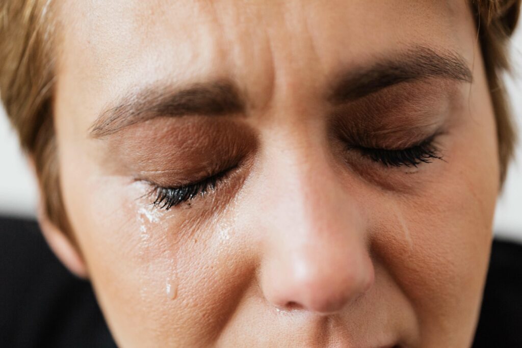 A woman cries as she struggles with feelings of depression. Help is available in Therapy for Depression in Washington, DC.