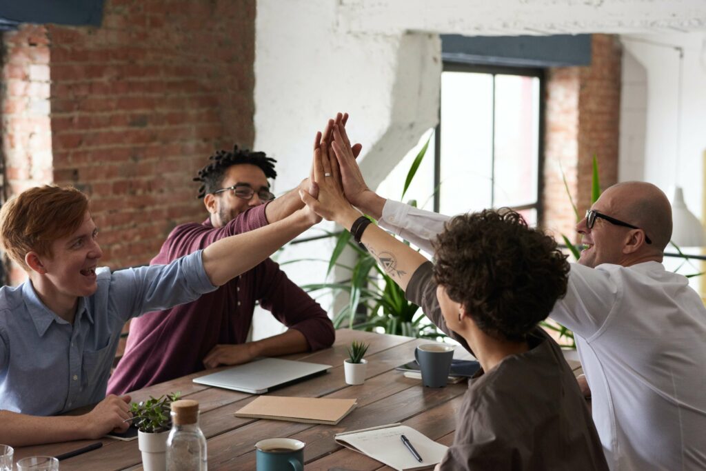 A group of coworkers celebrate a victory. Improve your relationships at work and at home with Therapy for Anxiety in Washington, DC.