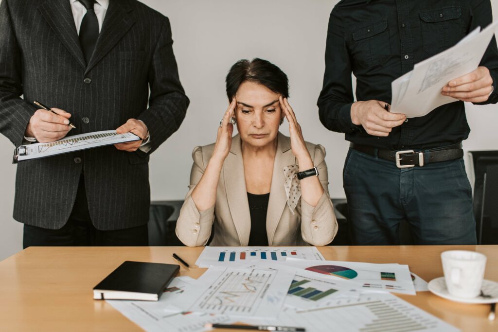 A high performing business woman is overwhelmed with anxiety at work and could benefit from Anxiety Therapy in Washington, DC.