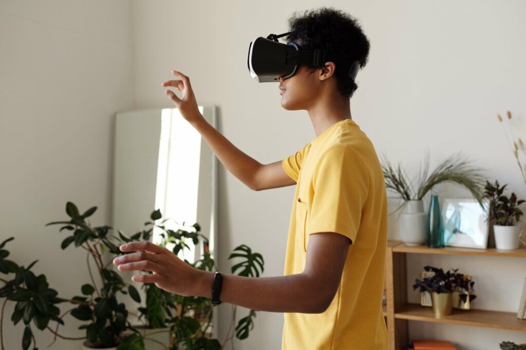 A teen in a yellow t-shirt plays on a virtual headset connecting with other teens during the holiday season. Learn how this outlet can be helpful in Therapy for anxiety in Washington, DC.