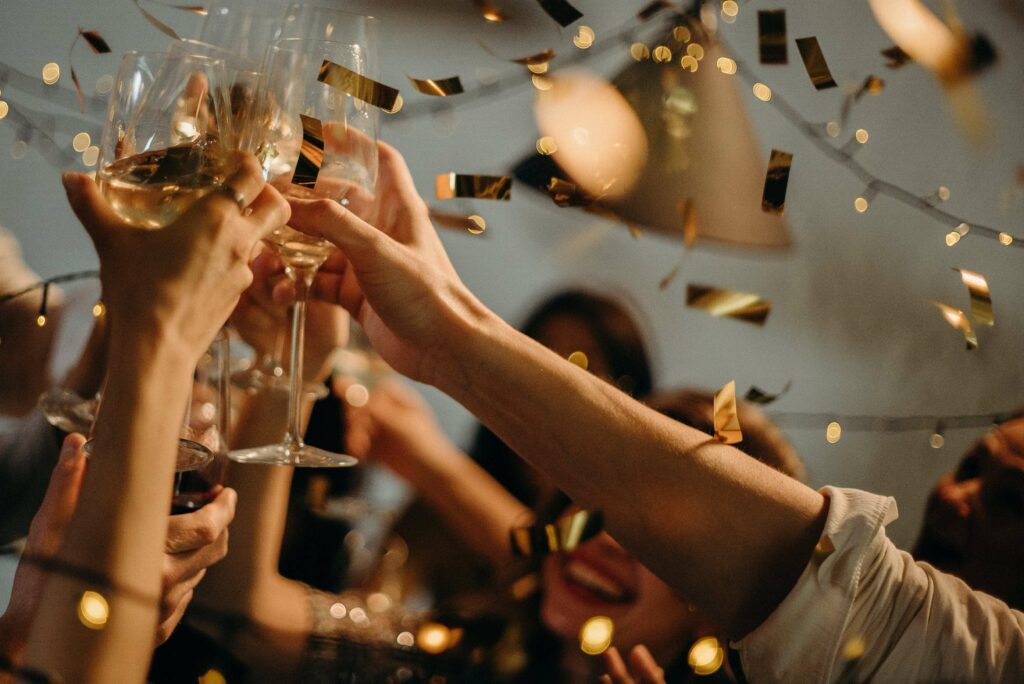 A group of friends toast the new year as confetti falls from the sky representing the good things that are possible when you face depression in Therapy for Depression in Washington, DC.