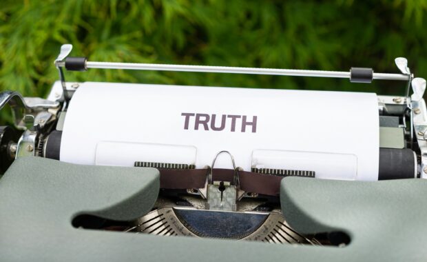 Typewriter with a paper that has "Truth" typed on it.