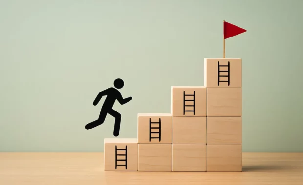 A black figure running up steps representing goals