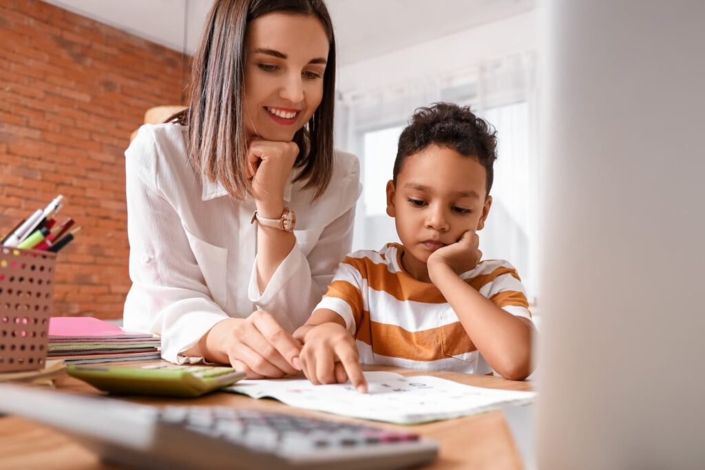 Tutor helping child focus on homework, showing academic support for students with ADHD and anxiety in the DMV area