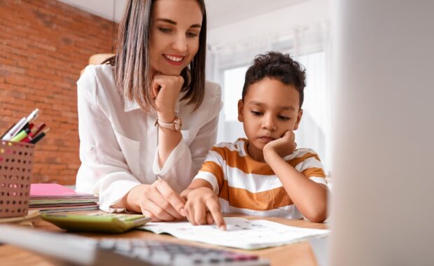 Tutor helping child focus on homework, showing academic support for students with ADHD and anxiety in the DMV area